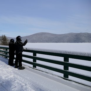 Snowmobilers looking at the lake Témiscouata, in Bas-Saint-Lauren